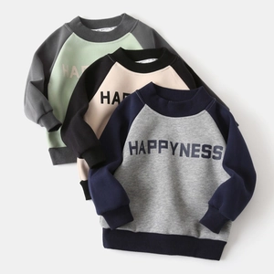 Close-up of three kids' color-block sweatshirts with rib-knit cuffs and HAPPYNESS print