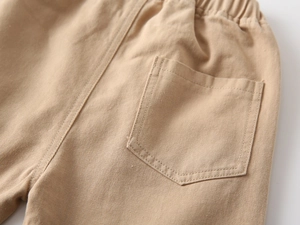 Close-up of khaki children pants featuring elastic waistband and neat back pocket stitching