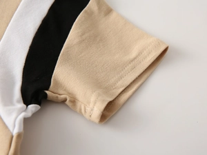 Detailed close-up of tricolor striped sleeve cuff with high-quality double stitching