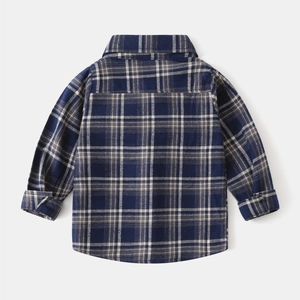 Close-up showing textured brushed fabric and classic grid pattern of boys plaid shirt