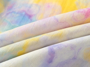 Macro detail of toddler boys' shirt featuring colorful digital watercolor textile patterns