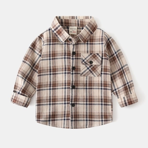 Detail view of boys' plaid flannel shirt showing breast pocket and tortoiseshell buttons