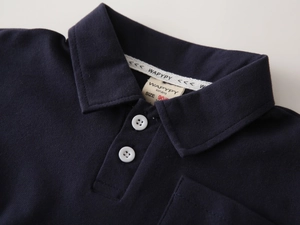 Detailed view of kids navy polo collar with buttons and breathable cotton texture