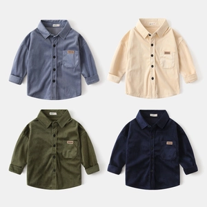 Detail of corduroy texture and button pockets on children long sleeve shirts
