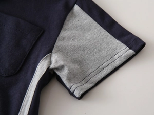Detail of navy and grey contrast patchwork fabric with pique texture and chest pocket