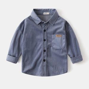Detailed view of kids blue corduroy shirt featuring a chest pocket and branded labels