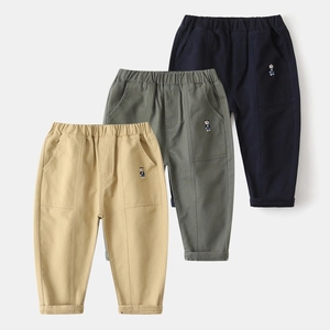 Detail of kids cotton casual pants featuring elastic waistband and cute bear embroidery