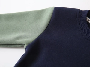 Close-up of ribbed crewneck and contrast sleeves on warm fleece sweatshirt for boys
