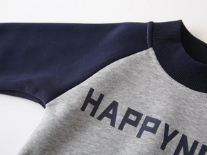 Detail of blue ribbed neckline and black Happy print on grey fleece sweatshirt