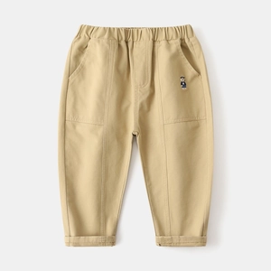 Detail of kids khaki trousers featuring a cute bear embroidery and elastic waistband