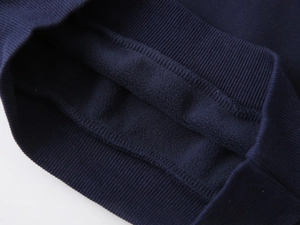 Close-up of navy blue thick fleece lining and ribbed cuff on children's warm sweatshirt