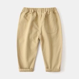Detail of khaki cotton trousers for boys featuring an elastic waist and a single back pocket