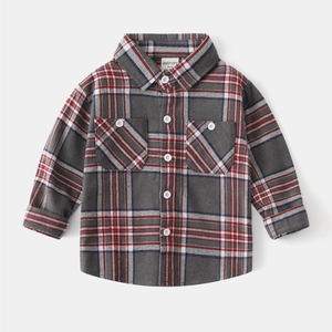 Detailed flat lay of boys grey flannel plaid shirt with button pockets and soft texture