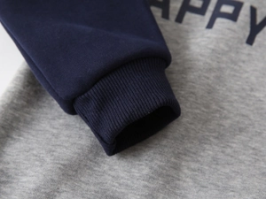 Detail of boys' fleece sweatshirt with ribbed cuffs and navy contrast sleeves
