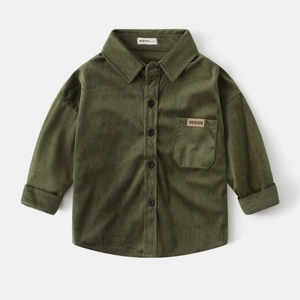 Close-up of the olive green corduroy fabric texture and pocket detail on child shirt