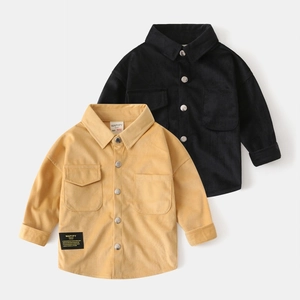 Detail of children's corduroy shirts with metal buttons and symmetric double pockets