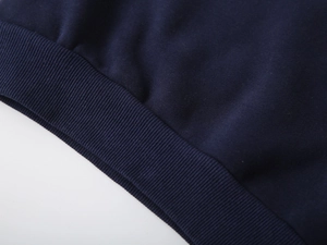 Close-up of the dark blue ribbed cuff and hem texture on kids thickened warm sweatshirt