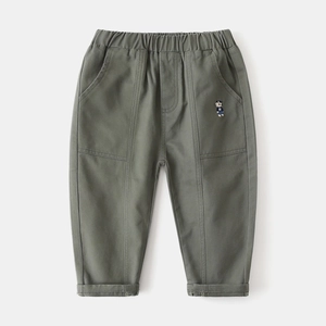 Detail of army green kids trousers featuring an elastic waist and cute bear embroidery
