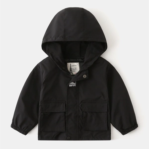 Detail of kids hooded windbreaker with large pockets and double closure system