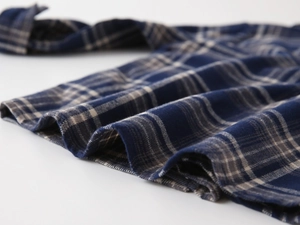 Close-up of soft blue and grey plaid flannel fabric showing high-quality woven texture
