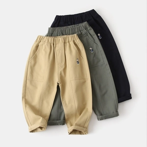 Detail of children's cotton pants with elastic waistband and cute bear embroidery