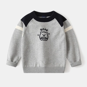 Detail of grey knitted kids sweater with navy raglan sleeves and bear graphic
