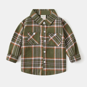 Detailed close-up of flannel plaid pattern and breast pockets on boys long sleeve shirt
