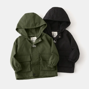 Detail of kids hooded jackets with utility pockets and zip closure in green and black