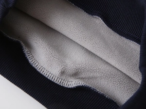 Macro detail of navy ribbed cuffs and thick grey fleece lining for boys winter hoodies