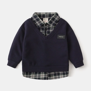 Detail of boys navy knit sweatshirt with green plaid shirt collar and fashion patch