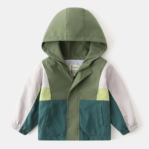 Detail of kids hooded jacket with color-block design and fluorescent yellow accents