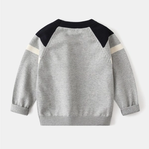 Detail of ribbed cuffs and contrasting raglan sleeves on children's knitted sweater