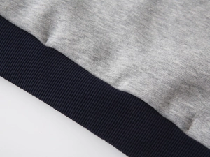 Detail view of grey heather knit fabric with dark blue ribbed cuffs for boys sweatshirt