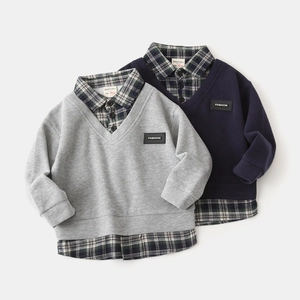 Detail view of boys' mock two-piece sweater with plaid collar and knitted texture
