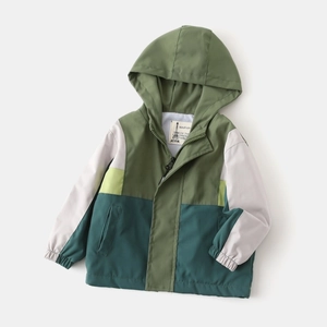 Detail of color-block hooded jacket showing high-quality zipper and elastic cuffs