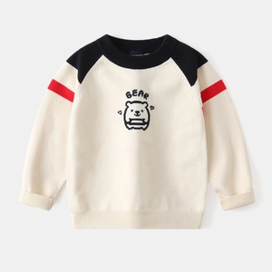 Detail of baby bear knitted sweater with navy raglan sleeves and ribbed cuffs
