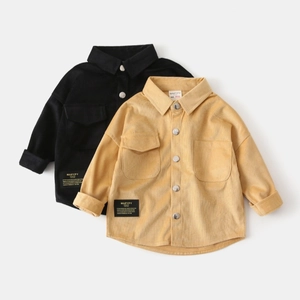 Detailed view of kids' corduroy shirts featuring metal buttons and stylish woven labels