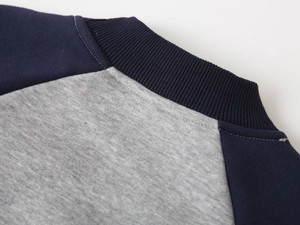 Close-up of navy blue ribbed neckline and premium grey knit fabric on warm boys sweatshirt