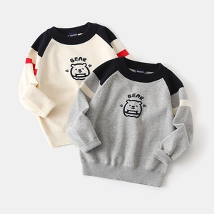 Detailed knit texture of boys cartoon bear sweater with raglan sleeves and ribbed cuffs