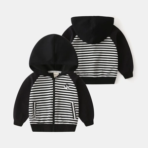 Detail of children's zip-up hoodie featuring black and white stripes and cartoon print