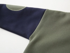Detail showing contrast sleeve patches and neat stitching on kids fleece hoodie