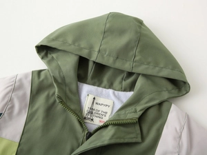 Close-up of kids hooded jacket featuring cozy sherpa lining and soft brand neck label