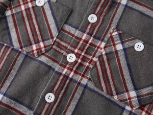 Macro detail of boys plaid shirt with brushed fabric texture and chest pockets