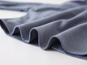 Macro shot of dark blue corduroy fabric texture for kid's shirt with fine ribbed detail
