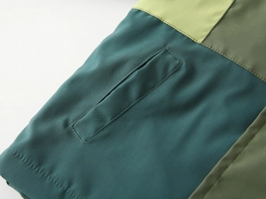 Detail of color-block kids jacket showing quality stitching on side pocket