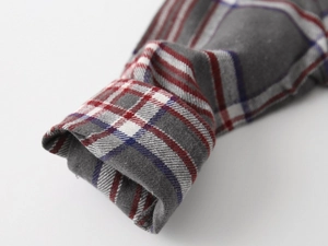 Detailed macro view of the checkered cotton sleeve cuff with fine stitching and soft texture