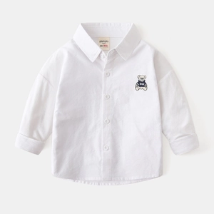 Detail of white cotton boy's shirt with cartoon bear embroidery and single-breasted buttons