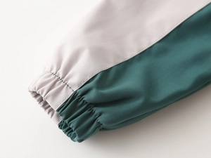 Macro detail of elastic cuffs and contrast stitching on children's patchwork jacket