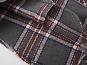 Close-up of boys' plaid shirt showing grey and red brushed cotton flannel fabric texture