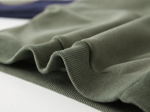 Detail shot of olive green ribbed cuffs on fleece-lined children's sweatshirt